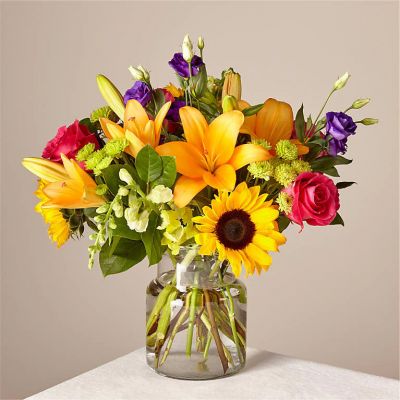 Make this day their best day. Our local florist handcraft a colorful array of flowers in a clear glass vase to create a celebration in bloom. Perfect to give for a special reason or to simply share a smile.