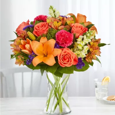 Putting a bright start in somebody’s day starts with a beautiful gift. Our delightfully vibrant bouquet is filled with a medley of blooms in cheerful pops of orange, pink and yellow, with plenty of lush greenery mixed in. Designed by the talented Breanna Cartwright from Fresh Ideas Flowers Company in Modesto, California, it’s the perfect pick-me-up surprise, whatever the sentiment.