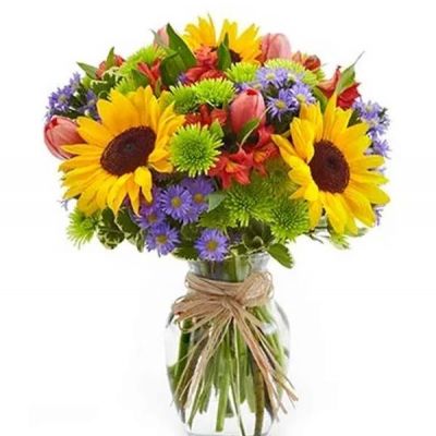 The essence of a Europe garden comes to life in all its grandeur with this bright assortment of alstroemeria, button poms, Monte casino, sunflowers and tulips arranged in an elegant clear glass vase.