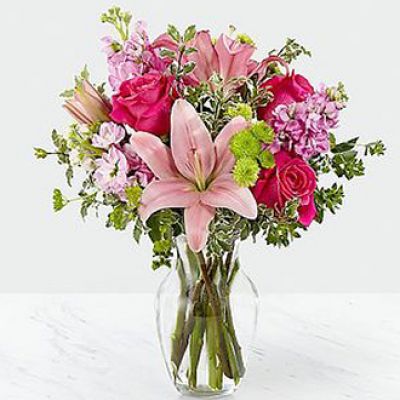 The Pink Posh Bouquet is chic and pink to help you celebrate life's most treasured moments in style! Hot pink roses are bright and beautiful arranged amongst pink Asiatic Lilies, pink gilly flower, green button poms, bupleurum and lush greens to create that perfect gift of flowers. Presented in a clear glass vase, this blushing fresh flower arrangement is ready to send your sweetest wishes in honor of a birthday, an anniversary, or as a way to express your thanks and gratitude.

STANDARD bouquet is approx. 16H x 13W.
DELUXE bouquet is approx. 17H x 14W.
PREMIUM bouquet is approx. 18H x 15W.