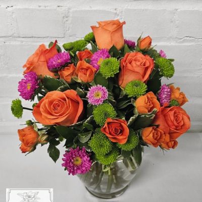 These beautifully vibrant flowers are sure to lighten anyone's day with a combination of blossoms carefully arranged for maximum enjoyment!