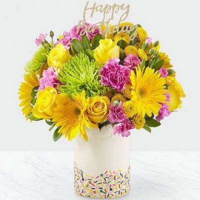 It’'s true: sprinkles make everything better. Overflowing with roses, carnations, gerbera daisies and a glittering “Happy Birthday” pic, this handcrafted bouquet puts the cherry on top of any celebration. Good bouquet is approx. 12H x 12W. Better bouquet is approx. 13H x 13W. Best bouquet is approx. 14H x 14W

STANDARD
C Quantity Color Description
2 Yellow 50 cm Standard Rose
2 Yellow Gerbera
2 Hot Pink Standard Carnation
2 Green Disbud Pom - Fuji/Spider
2 Yellow Button Pom
2 Hot Pink Miniature Carnation
1 Green Green - Pittosporum
0.65 Green Floral Foam

DELUXE
C Quantity Color Description
4 Yellow 50 cm Standard Rose
4 Yellow Gerbera
4 Hot Pink Standard Carnation
2 Green Disbud Pom - Fuji/Spider
3 Yellow Button Pom
3 Hot Pink Miniature Carnation
2 Green Green - Pittosporum
0.65 Green Floral Foam

PREMIUM
C Quantity Color Description
7 Yellow 50 cm Standard Rose
5 Yellow Gerbera
6 Hot Pink Standard Carnation
3 Green Disbud Pom - Fuji/Spider
4 Yellow Button Pom
4 Hot Pink Miniature Carnation
2 Green Green - Pittosporum
0.65 Green Floral Foam