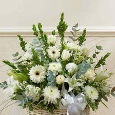 Send an expression of your sympathy and compassion with this sophisticated and elegant arrangement of white roses, hybrid lilies, Gerbera daisies and more. Appropriate for friends, family and business associates to send directly to the funeral home or to the family's home.