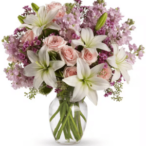 A beautiful arrangement of lilies, roses, and other flowers in pinks, creams, and pale lavender.