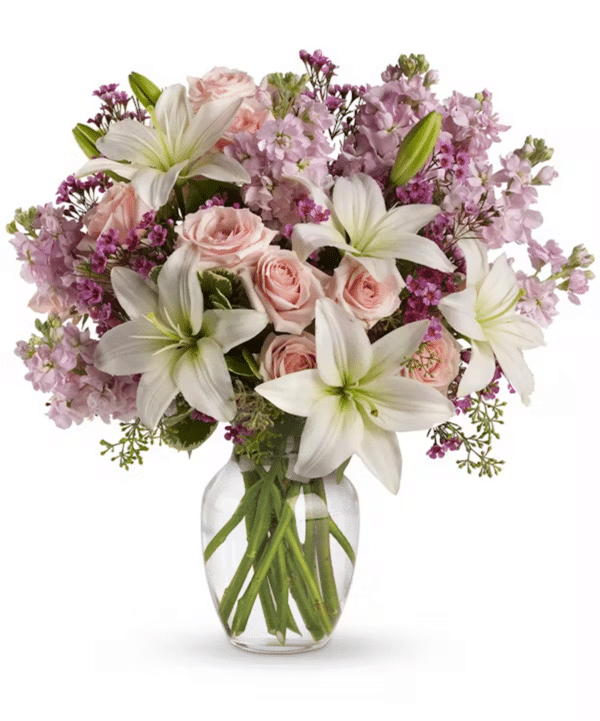 A beautiful arrangement of lilies, roses, and other flowers in pinks, creams, and pale lavender.