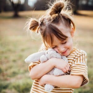 girl cuddling small bearington bunny